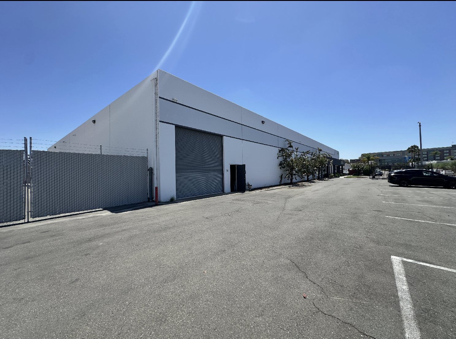 Front elevation of 1160 N. Cosby Way with gated parking and truck court
